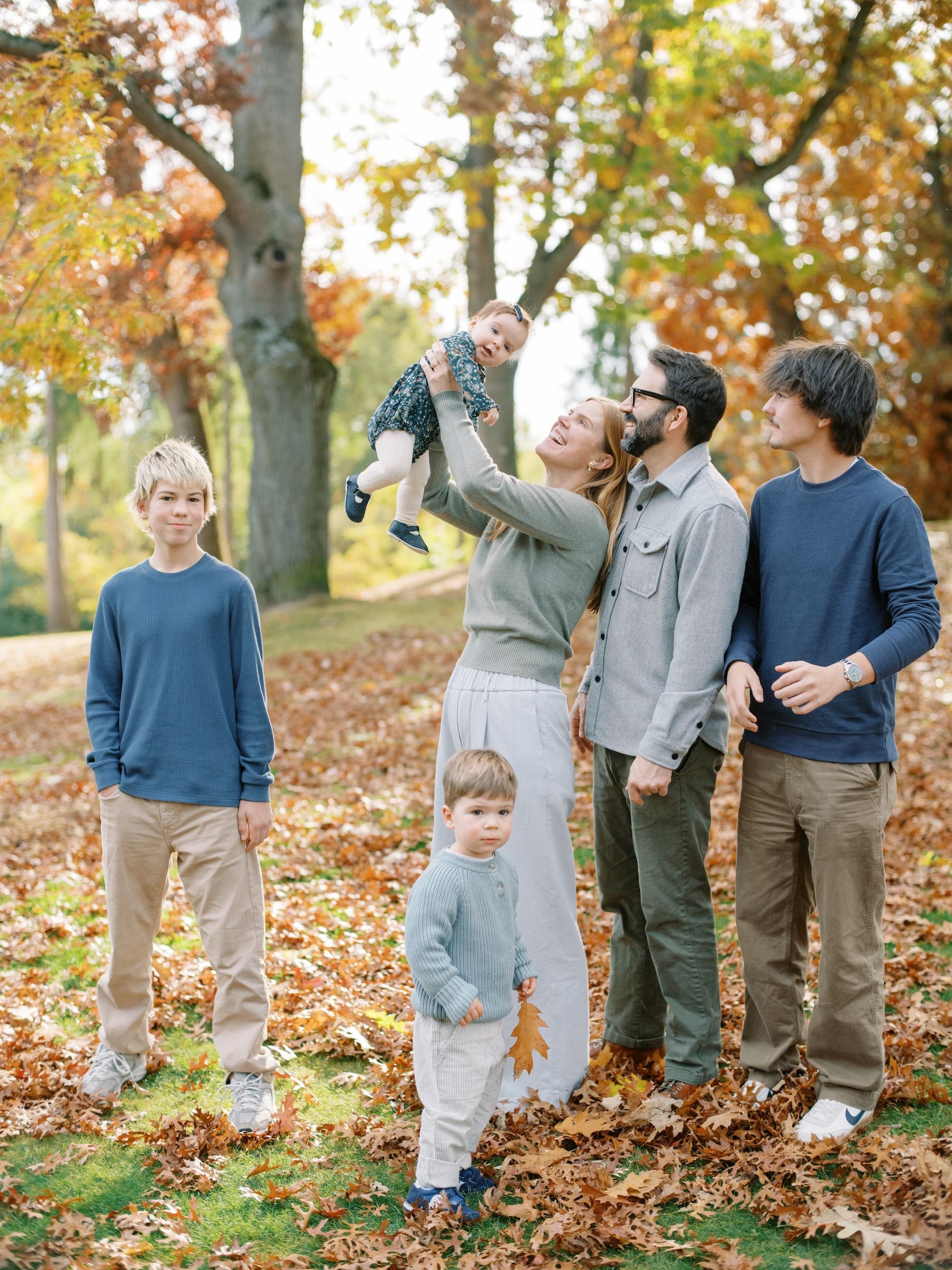 Seattle fall mini session: Family portrait with parents, baby, and sons in autumn leaves. Kauffman-Fall-2025-0010.jpg